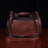 No. 17 Hunt Bag ladies' crossbody in dark Tobacco Brown American Buffalo and trimmed with American Alligator and Vintage Brown American Steerhide - 001 - back view on black background