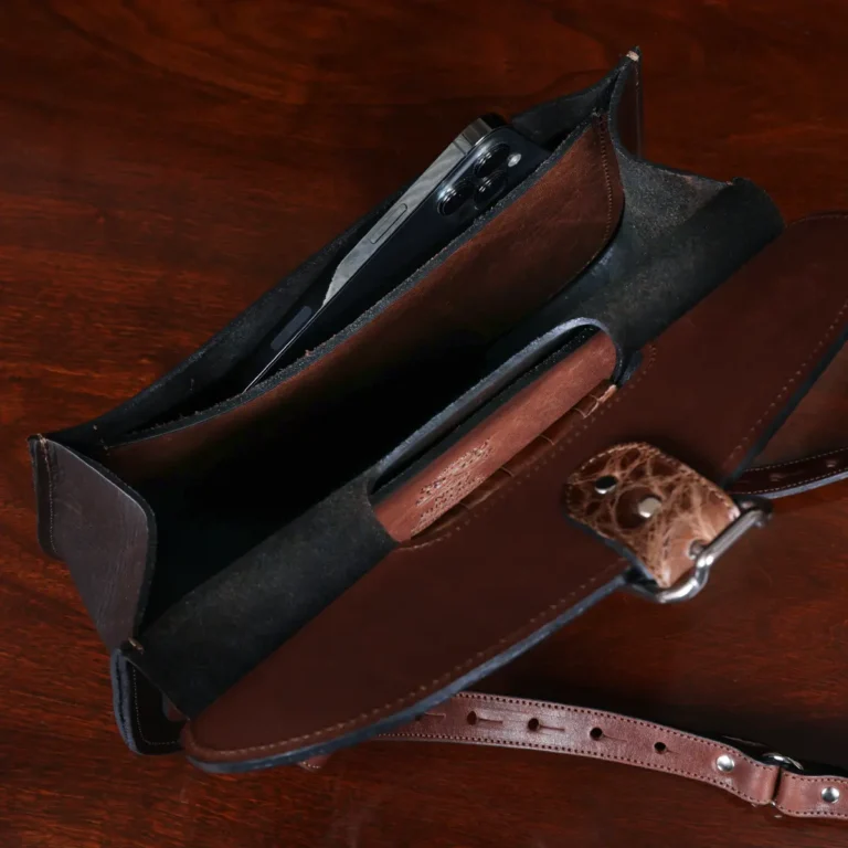 No. 17 Hunt Bag ladies' crossbody in dark Tobacco Brown American Buffalo and trimmed with American Alligator and Vintage Brown American Steerhide - 001 - open view with phone on black background