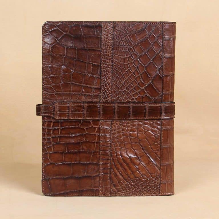 back view of brown american alligator leather portfolio on cream background