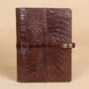front view of brown american alligator leather portfolio on cream background