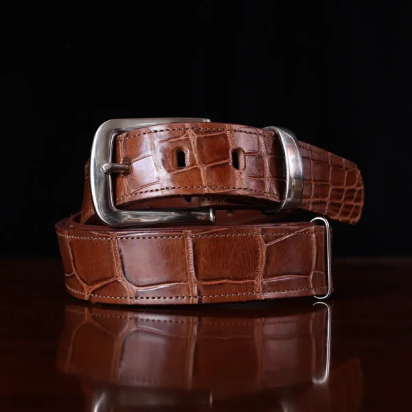 No. 4 Belt in brown American Alligator and silver buckle - ID 001 - front coiled view on black background