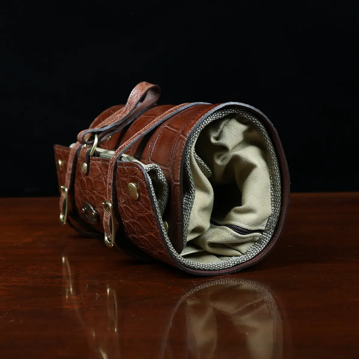 View larger image of CL - No. 2 Shave Dopp Kit in Vintage Brown American Alligator with No. 8 Khaki Cotton Canvas Lining - Serial Number 002 - side view on a wooden table