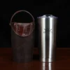 The front view of a leather tumbler sleeve show casing tobacco brown American buffalo and American alligator trim and the stainless steel tumbler insert.