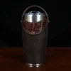 The front view of a leather tumbler sleeve show casing tobacco brown American buffalo and American alligator trim and the stainless steel tumbler insert.