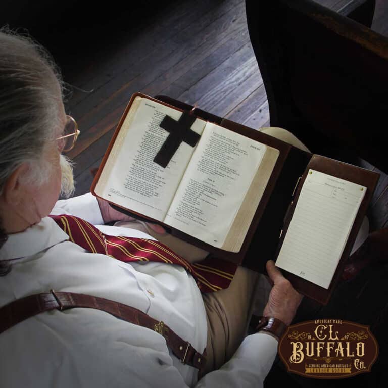 No. 1 Bible Cover in Tobacco Brown American Buffalo with vintage brown steerhide trim - open view of it in a man's lap, reading a Bible
