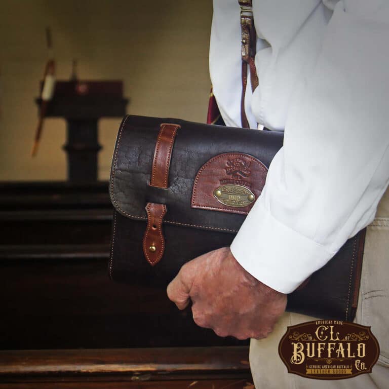 No. 1 Bible Cover in Tobacco Brown American Buffalo with vintage brown steerhide trim - Front view of man in a white shirt holding it down at his side