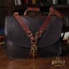 Dark brown American buffalo leather vintage-style No. 41 Commander Briefcase on antique table in darkly lit study
