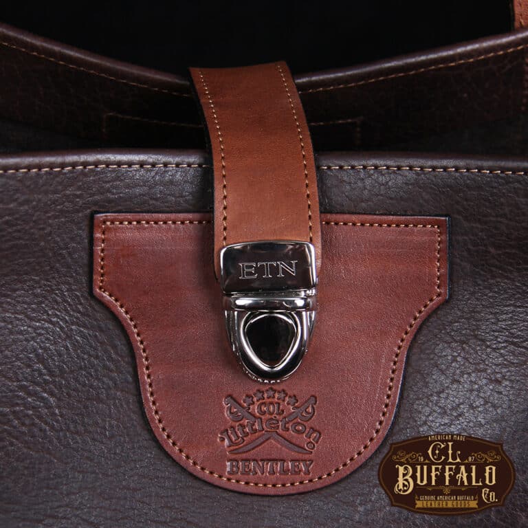 Bentley Tote in dark Tobacco Brown American Buffalo with contrasting vintage brown American Steerhide Trim - close up view of buckle closure with three initial engraving