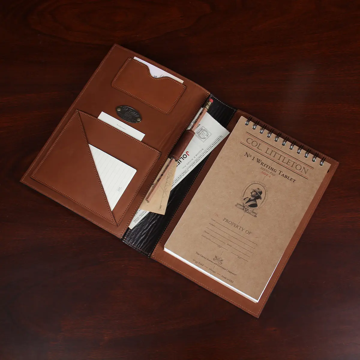 No. 1 Steno Padfolio in Tobacco Brown American Buffalo with Vintage Brown Steerhide Trim - open view showing notepad on the right and three pockets and the personalization plate on the left with extra paper tucked in to back pocket