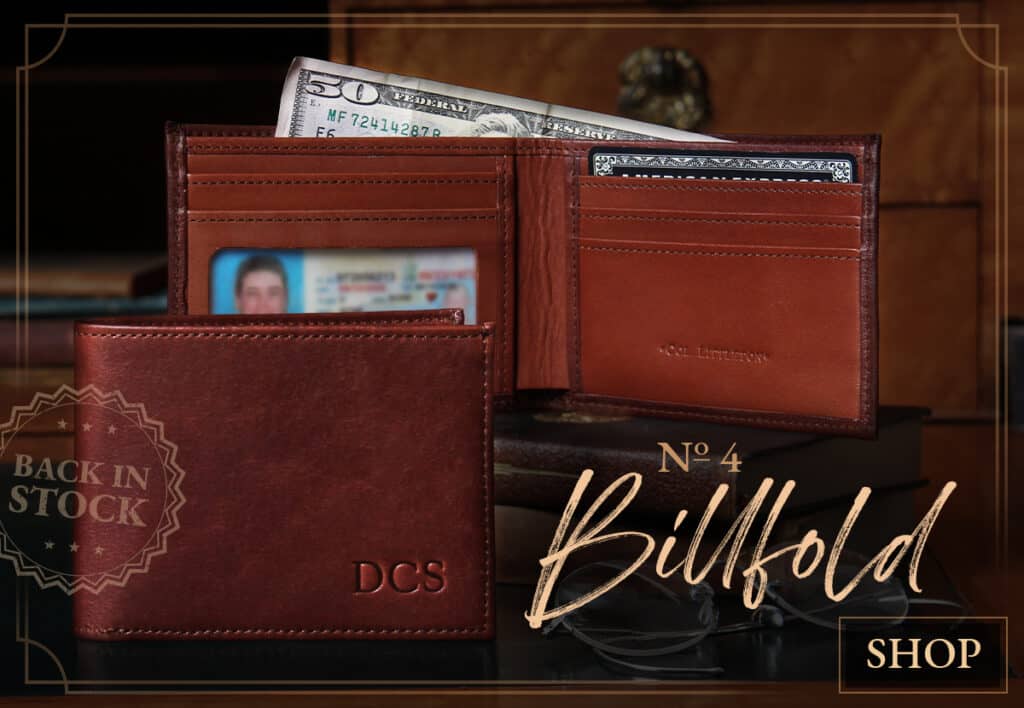 Back in stock No. 4 Billfold propped on book on a table with shop button in lower right hand corner