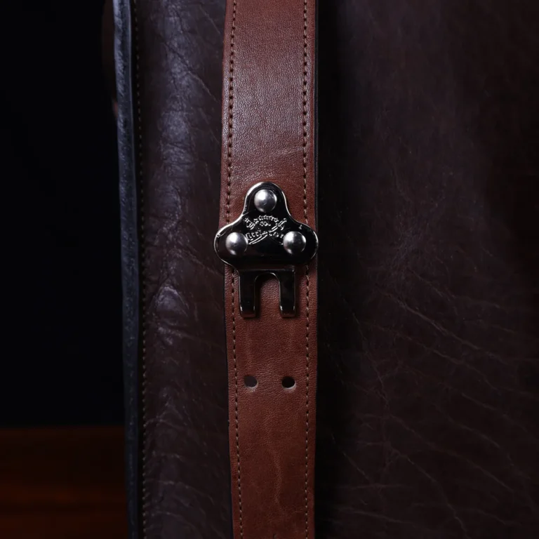 no 9 rover leather backpack in tobacco buffalo on a dark background- clasp view
