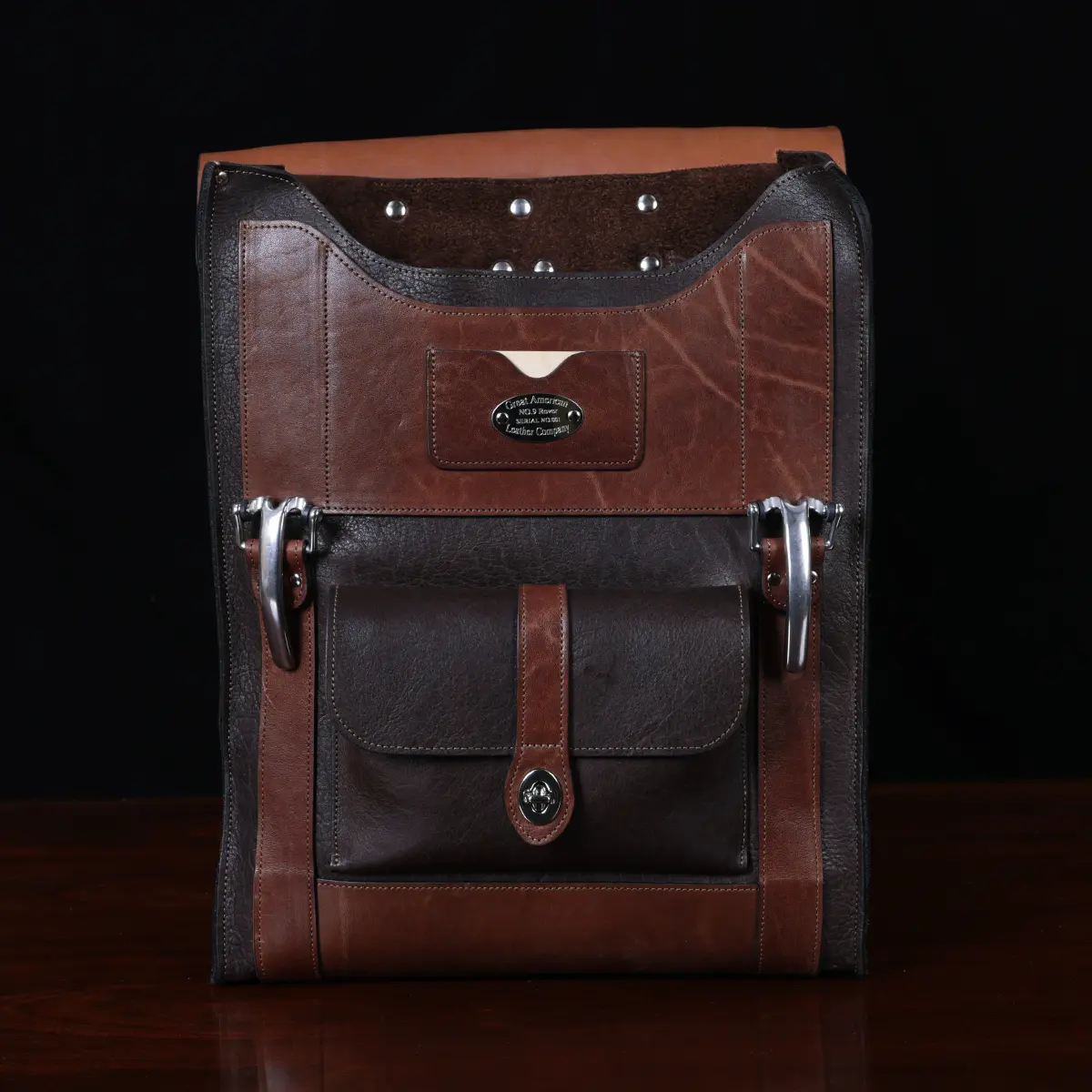 no 9 rover leather backpack in tobacco buffalo on a dark background- front open view