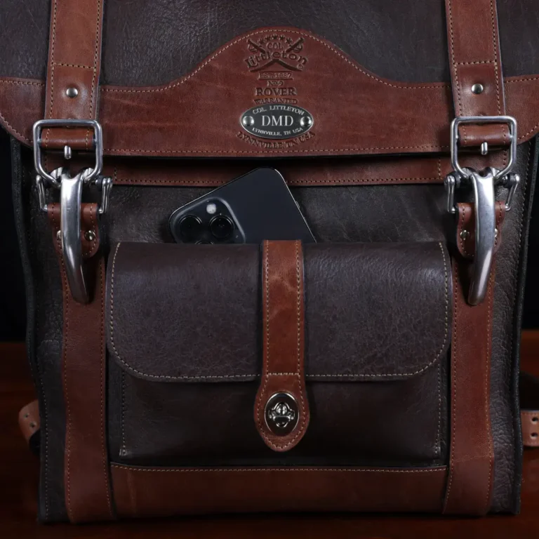 no 9 rover leather backpack in tobacco buffalo on a dark background- front view of pocket