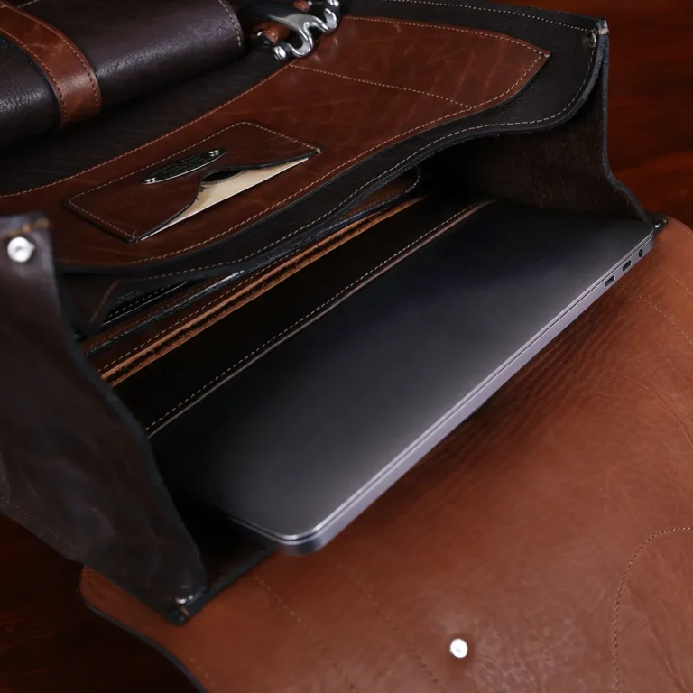no 9 rover leather backpack in tobacco buffalo on a dark background- open view of laptop