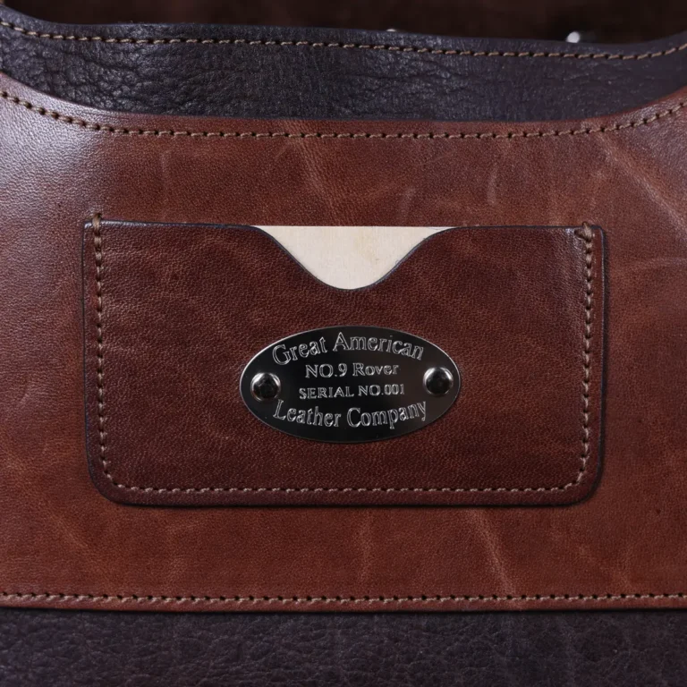 no 9 rover leather backpack in tobacco buffalo on a dark background- front view of business card holder and serial number