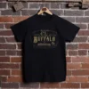 Front of a black colonel littleton tshirt