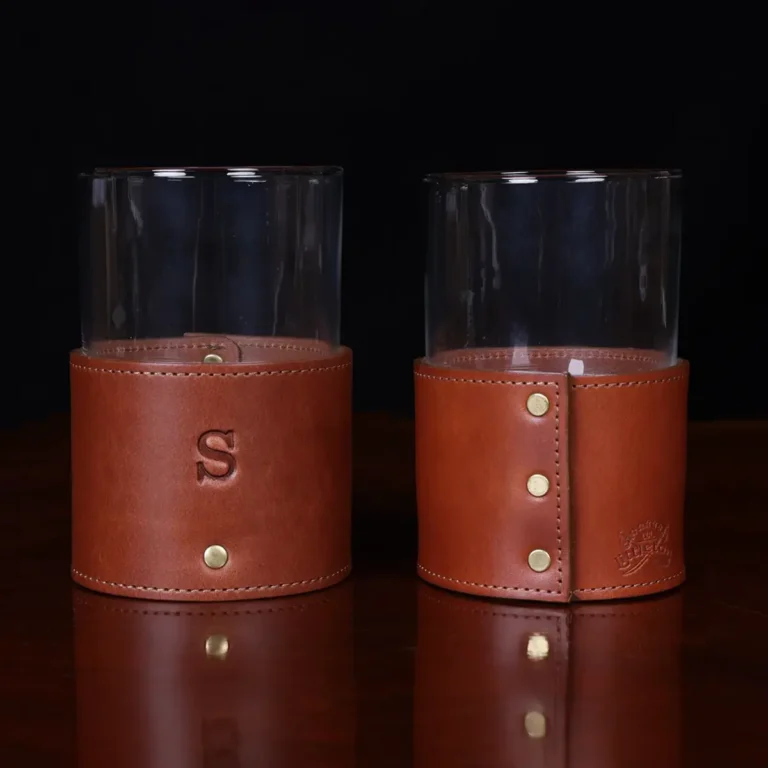 leather veranda glass sleeve and glass on wooden table with dark background - front and back view