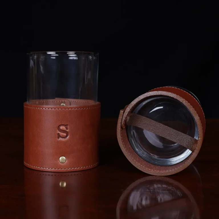 leather veranda glass sleeve and glass on wooden table with dark background - bottom view
