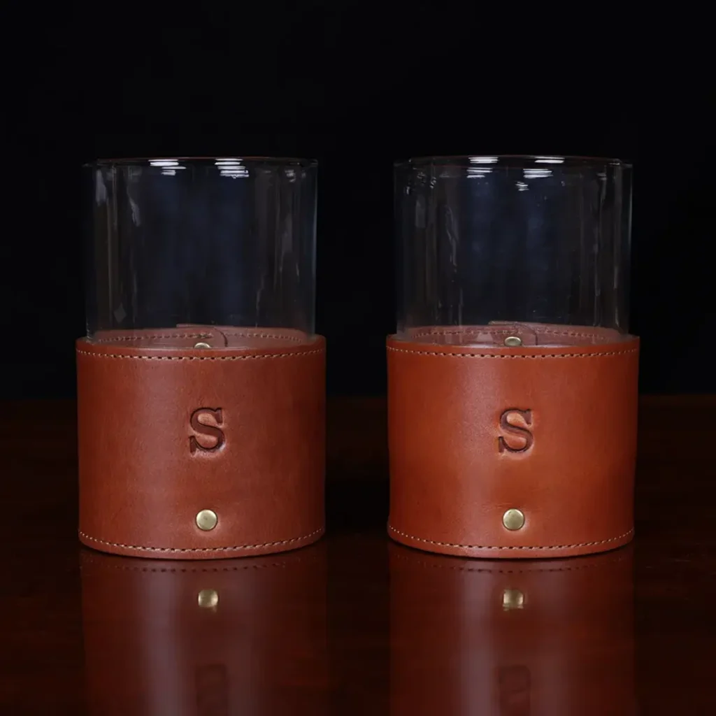 leather veranda glass sleeve and glass on wooden table with dark background - front and front view