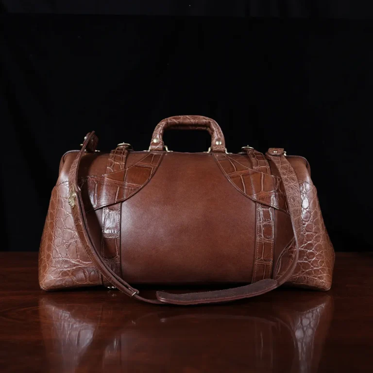 no 5 grip in steerhide with brown american alligator trim - back view - on a wood table with black background - ID 002