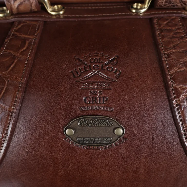 no 5 grip in steerhide with brown american alligator trim - front logo view - on a wood table with black background - ID 002
