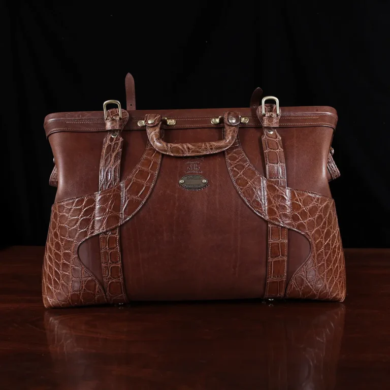 no 5 grip in steerhide with brown american alligator trim - front open view - on a wood table with black background - ID 002