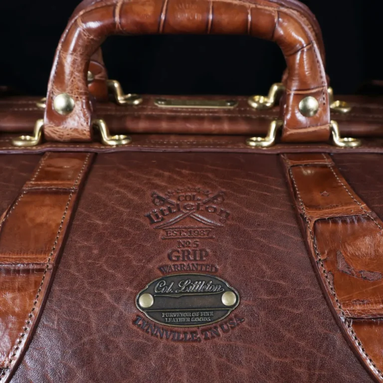 no 5 grip in steerhide with brown american alligator trim - logo view - on a wood table with black background - ID 001