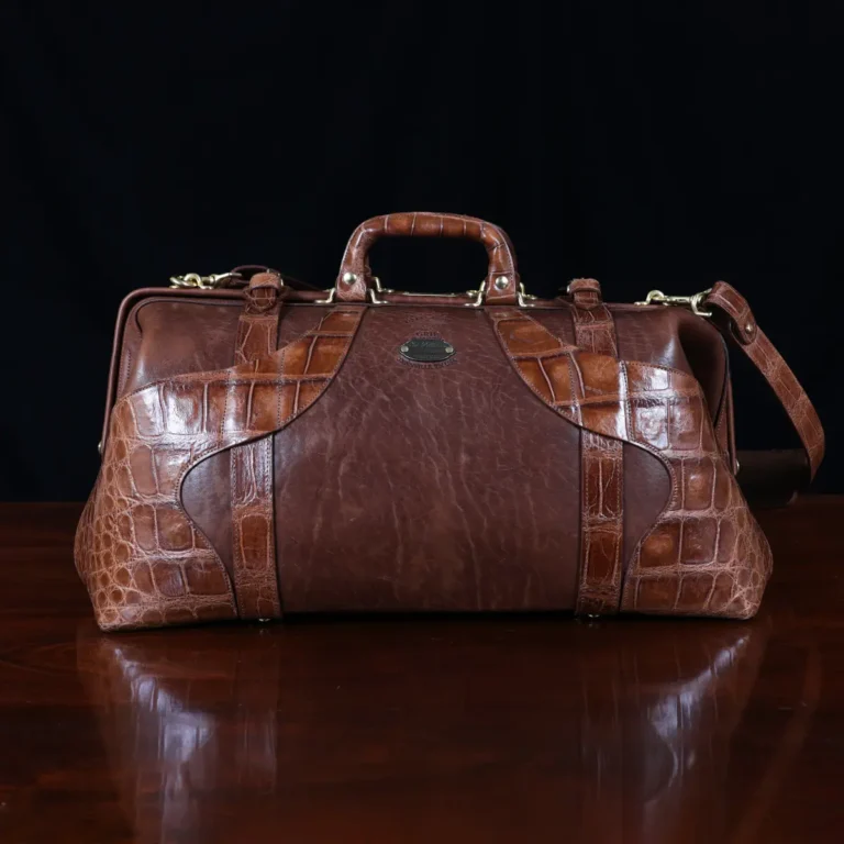 no 5 grip in steerhide with brown american alligator trim - front view - on a wood table with black background - ID 001