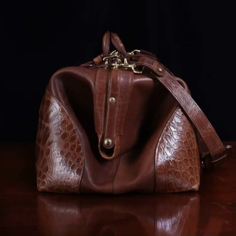 no 5 grip in steerhide with brown american alligator trim - side view - on a wood table with black background - ID 001