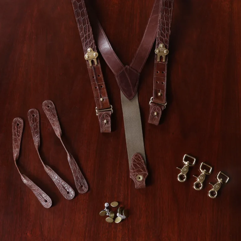 no 3 alligator suspenders - buttons - straps - hooks - on wooden table