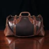 no 5 grip in tobacco buffalo with brown american alligator trim - front view - on a wood table with black background - ID 001