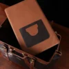 no 5 grip in tobacco buffalo with brown american alligator trim - inside view of panel - on a wood table with black background - ID 001