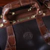 no 5 grip in tobacco buffalo with brown american alligator trim - top view of serial number - on a wood table with black background - ID 001