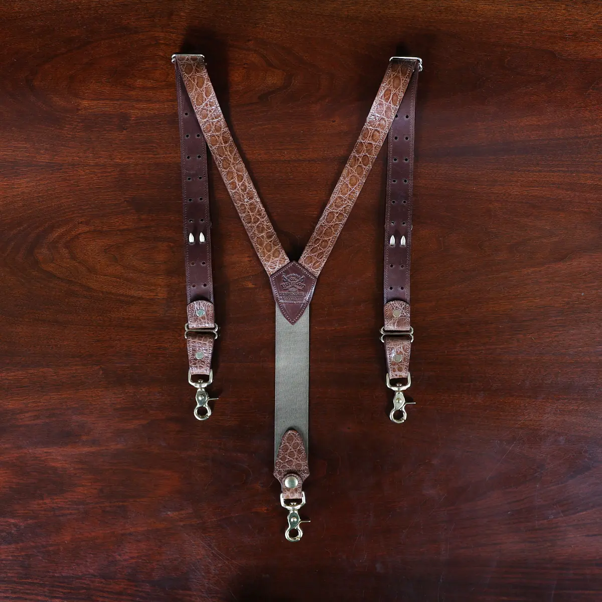 no 3 leather alligator suspenders on wood table - back view - id 001