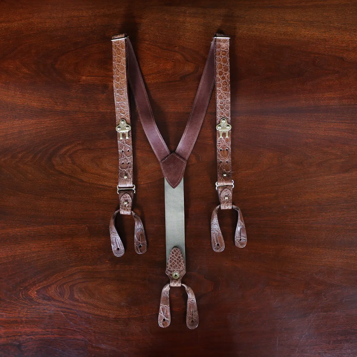 no 3 leather alligator suspenders on wood table - front view - id 001