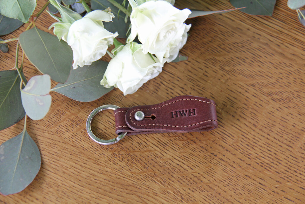 No. 6 Key Ring on a table with white roses