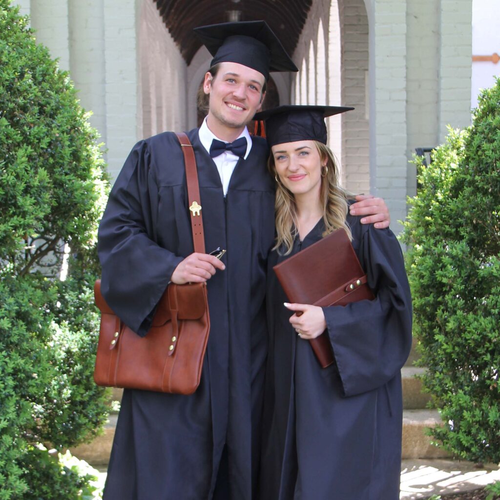 two graduates with a no. 18 portfolio and no. 16 document bag