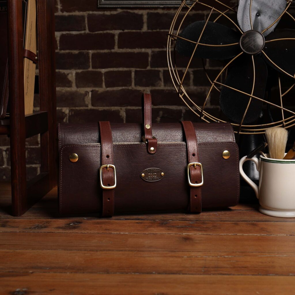 No. 2 Shave Dopp Kit in tobacco buffalo with No. 8 Khaki Cotton Canvas Lining - front view on a wooden table