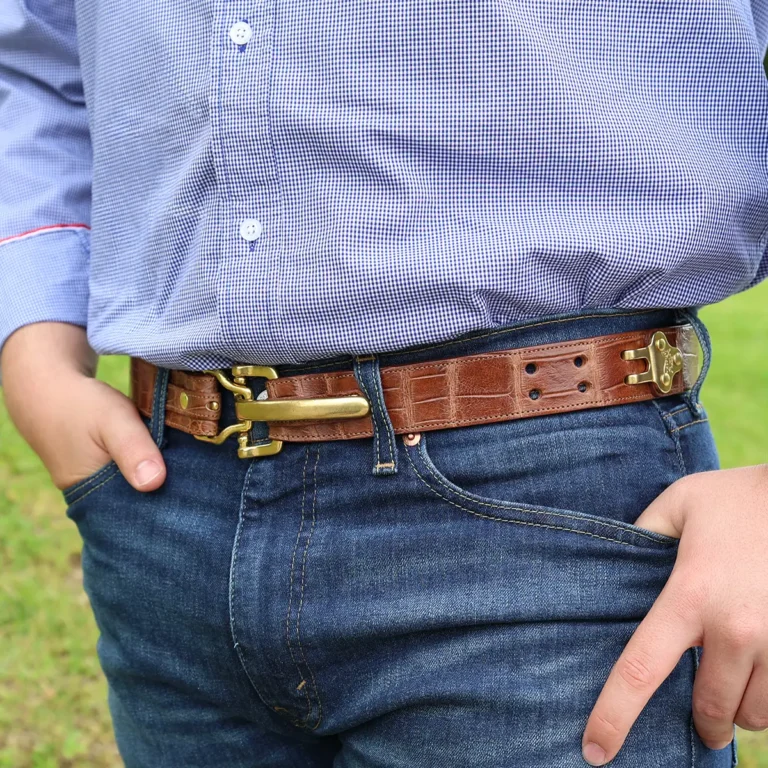 No. 5 Cinch Belt in American Alligator and brass buckle shown on a man