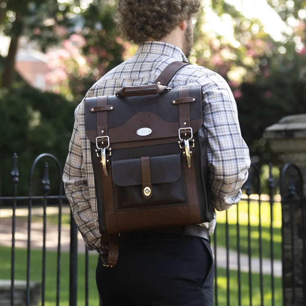 man wearing No. 9 Rover Backpack crafted from American Buffalo and American Steerhide on college campus