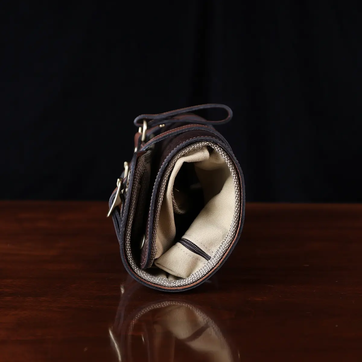 No. 2 Shave Dopp Kit in tobacco buffalo with No. 8 Khaki Cotton Canvas Lining - side view on a wooden table