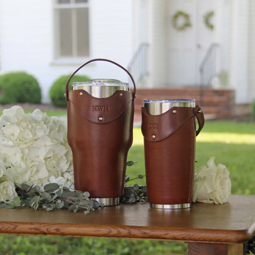 Two raveler tumbler sleeves in a wedding environment