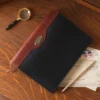 leather journal in black sitting on a vintage desk