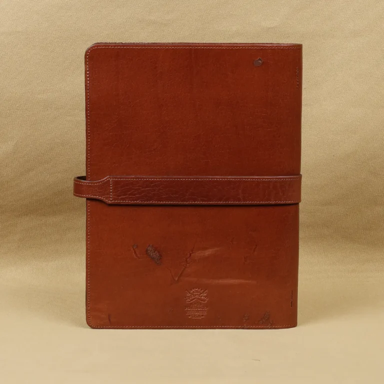 Rugged leather portfolio showing the front with brass hardware - back view