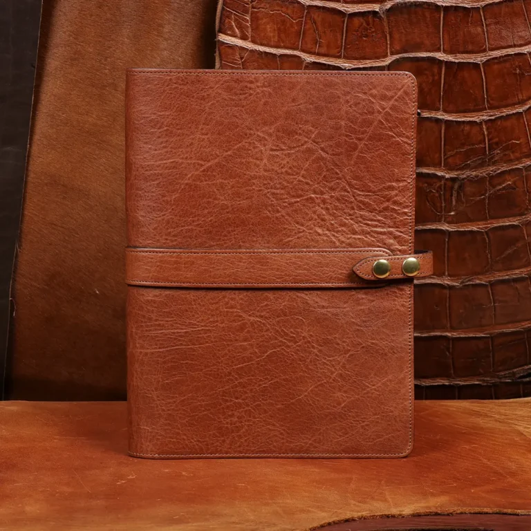 Rugged leather portfolio showing the front with brass hardware.