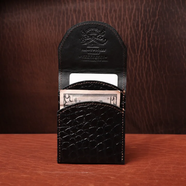 Front pocket wallet with flap in brown American Alligator - front view - 001 - on wood table with a dark background