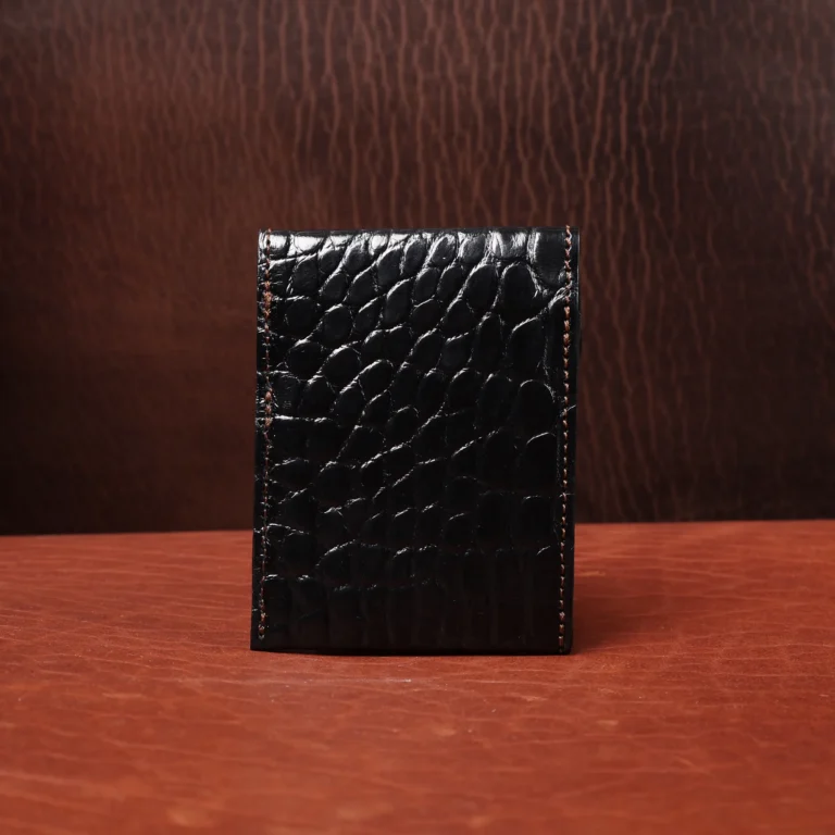 Front pocket wallet with flap in brown American Alligator - front view - 001 - on wood table with a dark background