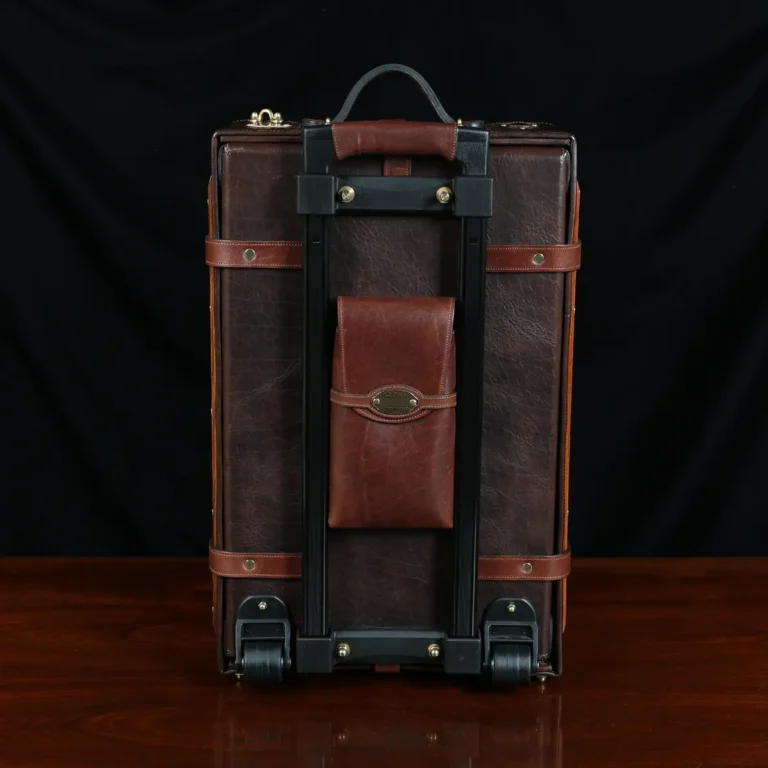no 3 travel trunk in american buffalo - showing back with a dark background on wood table