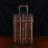 no 3 travel trunk in american buffalo - showing the front with a dark background on wood table
