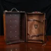 no 3 travel trunk in american buffalo - showing it open with a dark background on wood table
